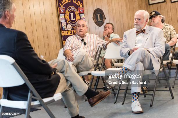 Charles Saverance, right, listens to U.S. Rep. Tom Rice during a congressional town hall meeting August 23, 2017 in Society Hill, South Carolina....