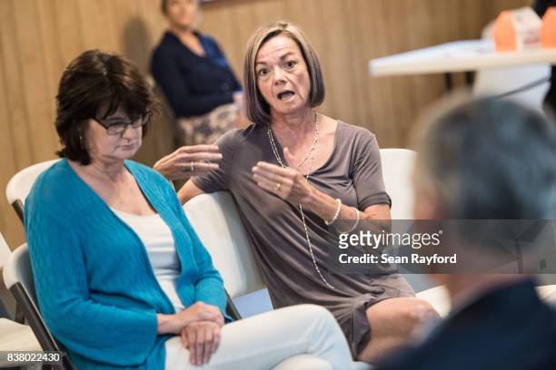 Wanda Hassler talks with U.S. Rep. Tom Rice about gerrymandering and partisanship during a congressional town hall meeting August 23, 2017 in Society...
