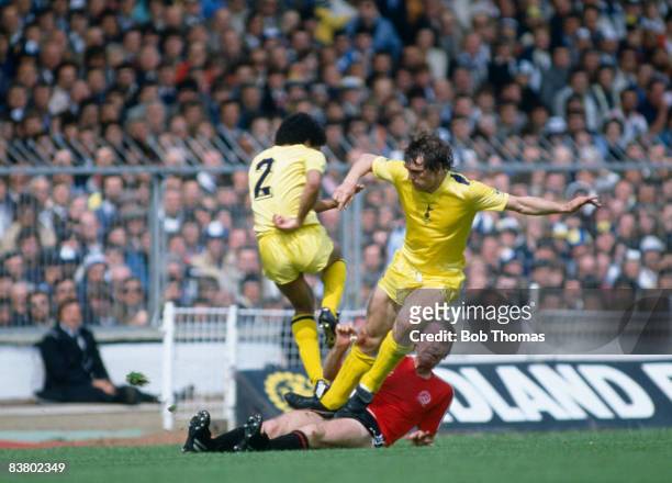 Tottenham Hotspur defenders Chris Hughton and Graham Roberts clash with Queens Park Rangers' Tony Currie during the FA Cup Final at Wembley, 22nd May...