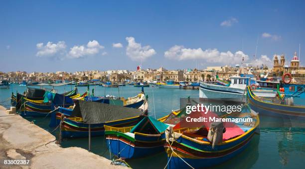 the village and the port with the typical boats - marsaxlokk stockfoto's en -beelden