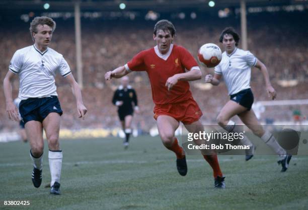 Liverpool's Kenny Dalglish moves onto the ball watched by Tottenham Hotspur defenders Paul Price and Paul Miller during the League Cup Final at...