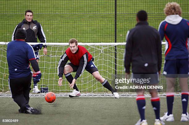 New Zealand rugby player Ali Williams prepares to make a save from a penalty kick during a game of soccer during the All Blacks training session at...