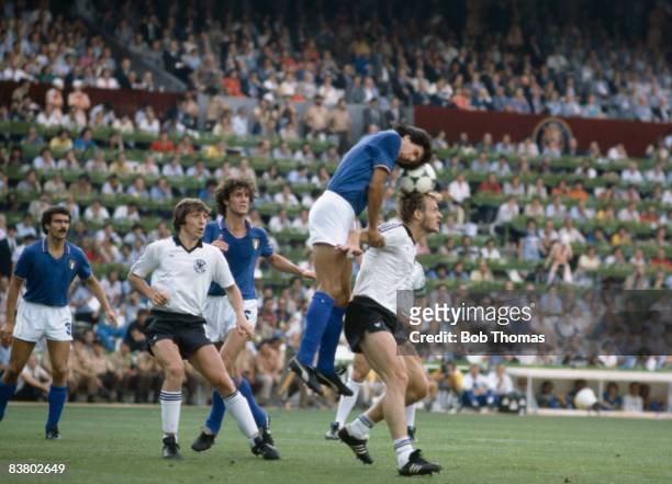 Italy's Gaetano Scirea climbs above West Germany's Hans Peter Briegel watched by Klaus Fischer and Fulvio Collovati during the World Cup Final at the...