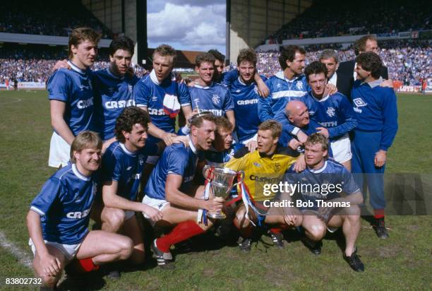 The Rangers team with their captain Terry Butcher celebrate with the Scottish Premier League Championship trophy after beating St Mirren at Ibrox...