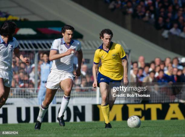 Arsenal's Liam Brady is chased by West Ham United's Trevor Brooking during the FA Cup Final at Wembley Stadium, 10th May 1980. West Ham United won...