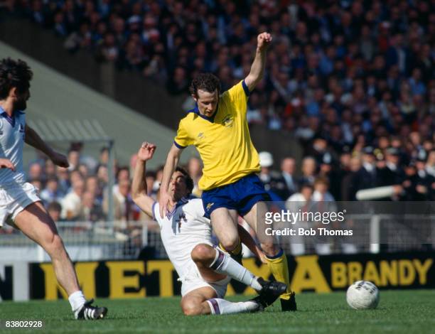 Arsenal's Liam Brady is tackled by West Ham United goalscorer Trevor Brooking during the FA Cup Final at Wembley Stadium, 10th May 1980. West Ham...