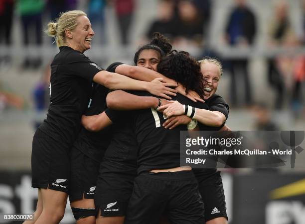 Portia Woodman of New Zealand is mobbed by team mates after scoring a try during the Womens Rugby World Cup semi-final between New Zealand and USA at...
