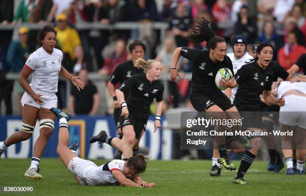 Portia Woodman of New Zealand breaks through the USA players to score a try during the Womens Rugby World Cup semi-final between New Zealand and USA...