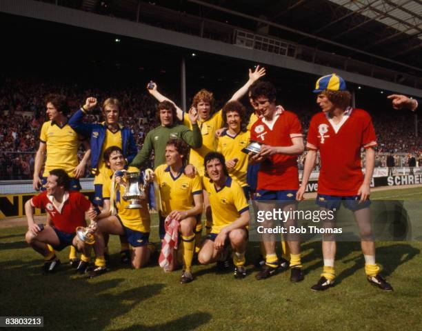 The Arsenal team celebrate with the trophy after defeating Manchester United 3-2 in the FA Cup Final at Wembley Stadium, 12th May 1979. Back row :...