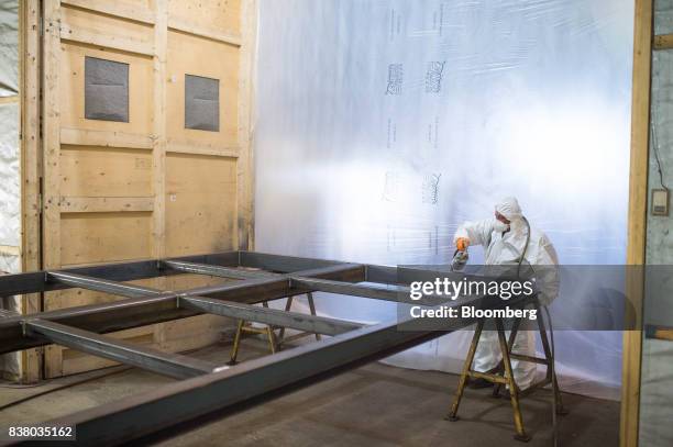 Painter sprays the bottom framework for a modular farming unit at the Modular Farms Co. Manufacturing facility in Cornwall, Ontario, Canada, on...