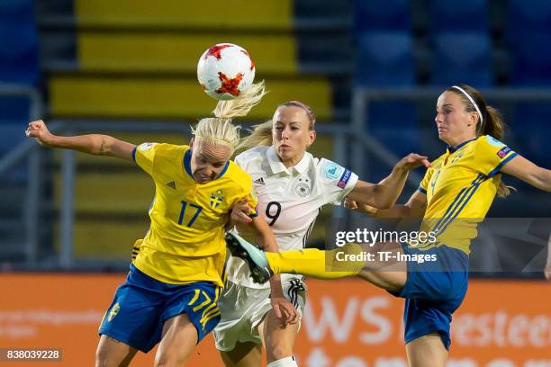 Caroline Seger of Sweden , Mandy Islacker of Germany and Lotta Schelin of Sweden battle for the ball l during the Group B match between Germany and...