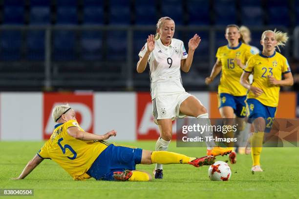 Nilla Fischer of Sweden and Mandy Islacker of Germany battle for the ball l during the Group B match between Germany and Sweden during the UEFA...