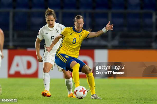 Babett Peter of Germany and Lotta Schelin of Sweden battle for the ball l during the Group B match between Germany and Sweden during the UEFA Women's...
