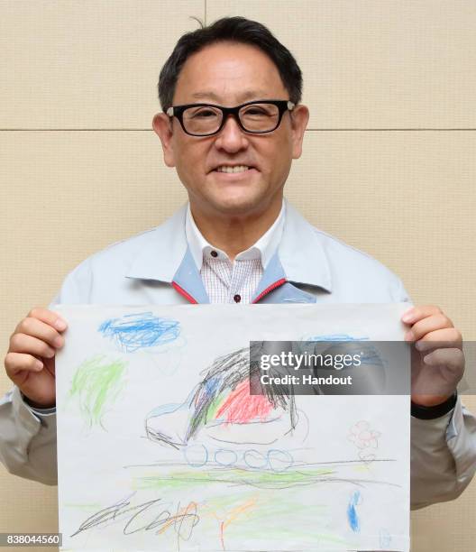In this handout image provided by Toyota Motor Corporation on August 23 Akio Toyoda, president of Toyota Motor Corporation holds the President's...
