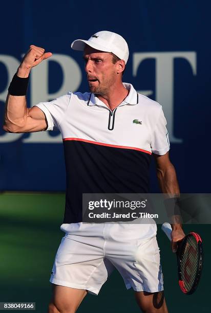 Roberto Bautista Agut of Spain reacts after defeating Marcos Baghdatis of Cyprus during the fifth day of the Winston-Salem Open at Wake Forest...