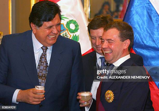 Russian President Dmitry Medvedev and his Peruvian counterpart Alan Garcia toast with a traditional Peruvian "pisco sour" drink, after Medvedev was...