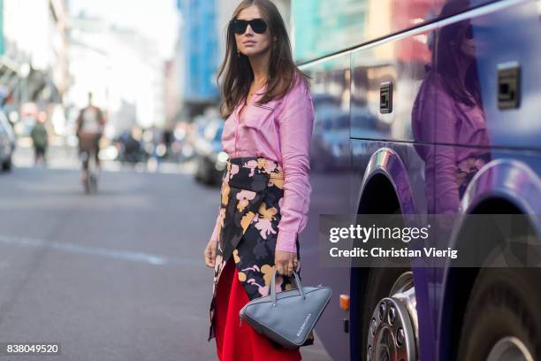 Darja Barannik wearing a skirt with floral print, pink blouse, grey Balenciaga bag outside iis Woodling on August 23, 2017 in Oslo, Norway.