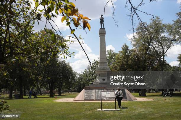 Visitor looks over Confederate Mound, a memorial to more than 4,000 Confederate prisoners of war who died in captivity at Camp Douglas and are buried...