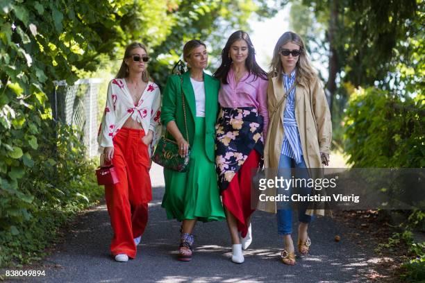 Emili Sindlev wearing a blouse, red flared pants, Janka Polliani wearing green coat, Gucci bag, Darja Barannik wearing skirt with floral print, pink...