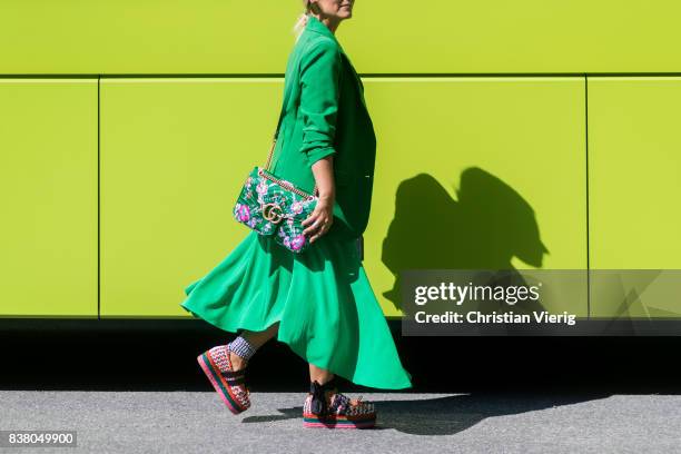 Janka Polliani wearing Miu Miu shoes, Gucci bag, green coat outside Cala Jade on August 23, 2017 in Oslo, Norway.