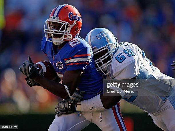 Receiver Deonte Thompson of the Florida Gators is tackled by defender Quintin Turner of the Citadel Bulldogs during the game at Ben Hill Griffin...