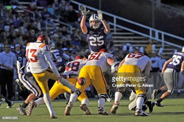 Defensive back Craig Boswell of the Kansas State Wildcats leaps into the air in an attempt to block the punt of punter Mike Brandtner of the Iowa...