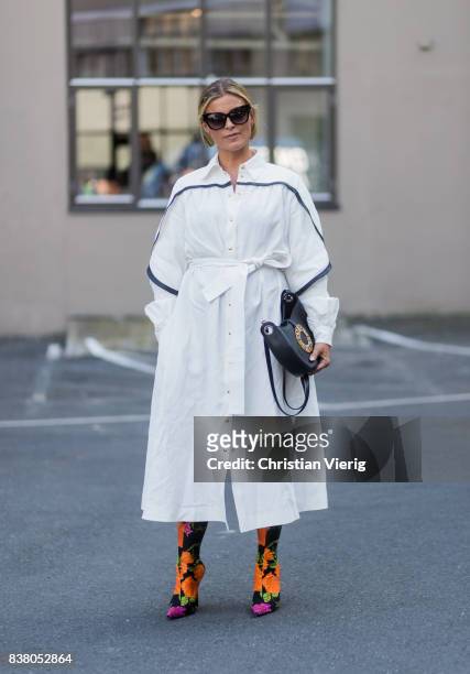 Janka Polliani wearing Loewe bag, white dress, Balenciaga sock boots outside FWSS on August 23, 2017 in Oslo, Norway.
