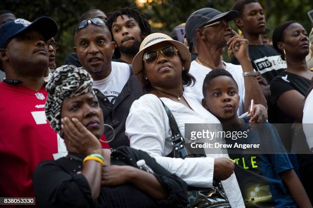 Activists listen to a speaking program during a rally in support of NFL quarterback Colin Kaepernick outside the offices of the National Football...