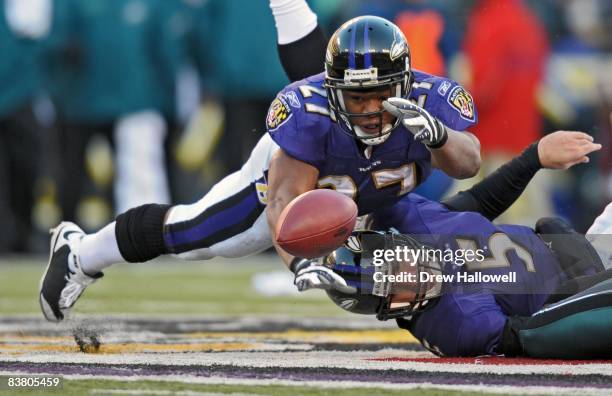 Running back Ray Rice of the Baltimore Ravens dives over teammate running back Ray Rice in order to grab a fumble during the game against the...