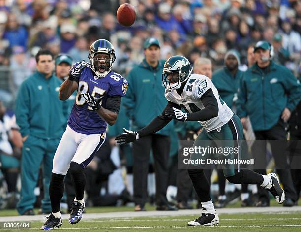 Wide receiver Derrick Mason of the Baltimore Ravens catches a pass in front of cornerback Sheldon Brown of the Philadelphia Eagles on November 23,...