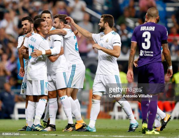 Cristiano Ronaldo of Real Madrid celebrates with teammates after scoring the first goal during the Trofeo Santiago Bernabeu match between Real Madrid...
