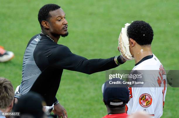 Manny Machado of the Baltimore Orioles gets pied by Adam Jones after hitting the game-winning home run in the 12th inning against the Oakland...