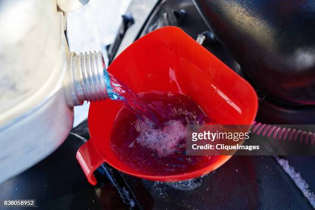 filling up vehicle through funnel filter - cliqueimages stock pictures, royalty-free photos & images