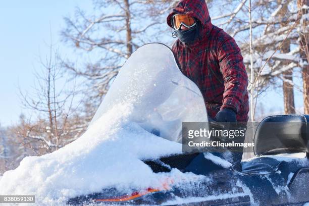 snowmobiling on beautiful winter day - cliqueimages stock-fotos und bilder