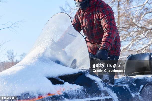experienced driver on snowmobile - cliqueimages stock-fotos und bilder