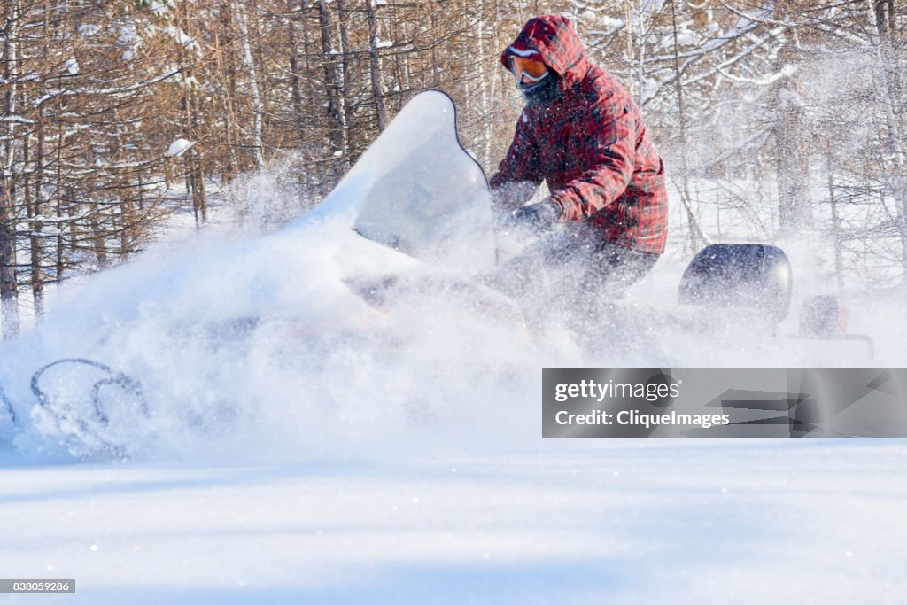 Man taking extreme snowmobile ride