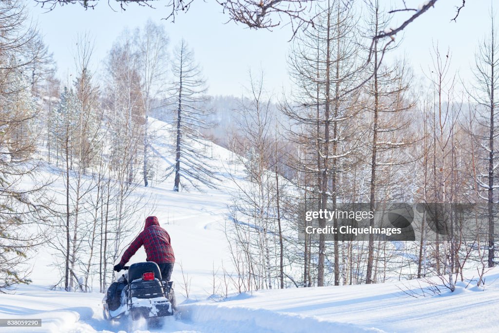Recreational snowmobile ride in woods