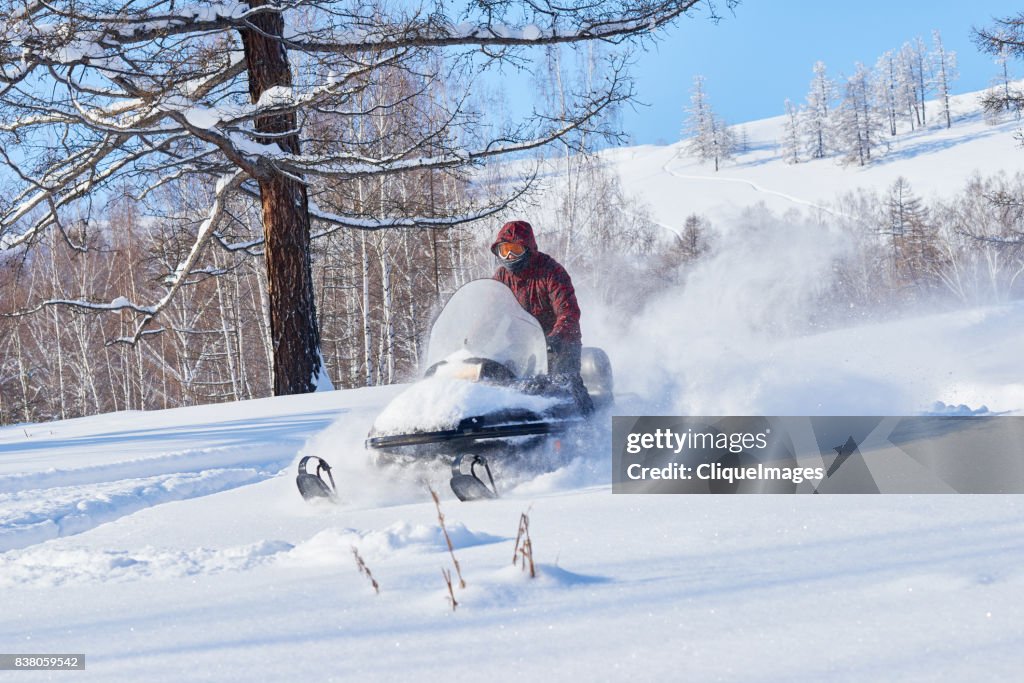 Snowmobile driver having fun