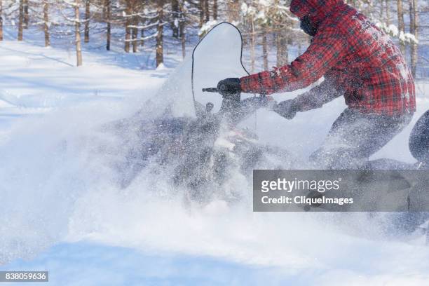fast and furious snowmobile ride - cliqueimages stock-fotos und bilder