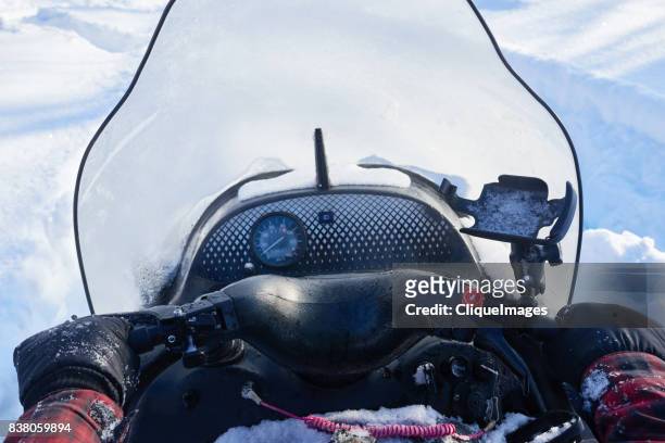 man driving snowmobile - cliqueimages stock-fotos und bilder
