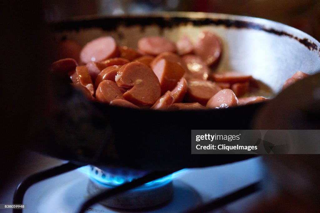 Tasty cut sausage in frying pan