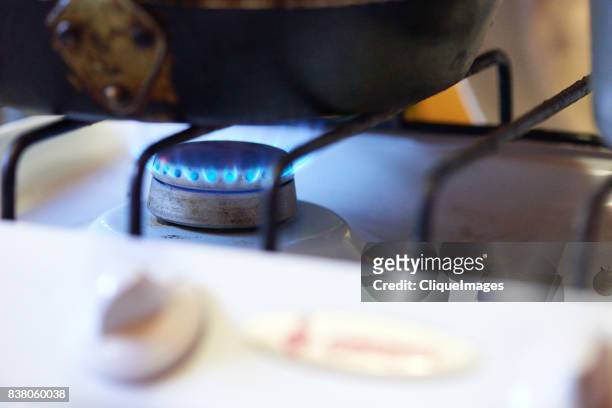 cooking on gas stove - cliqueimages stock-fotos und bilder