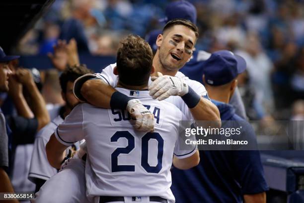 Kevin Kiermaier of the Tampa Bay Rays leaps into the arms of teammate Steven Souza Jr. #20 after hitting a two-run home run off of pitcher Marcus...