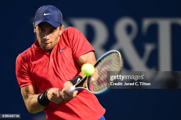 Borna Coric of Croatia returns a shot to John Isner during the fifth day of the Winston-Salem Open at Wake Forest University on August 23, 2017 in...