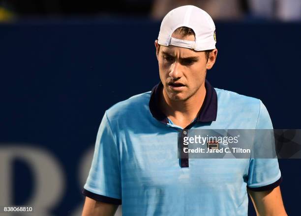 John Isner reacts after a point against Borna Coric of Croatia during the fifth day of the Winston-Salem Open at Wake Forest University on August 23,...