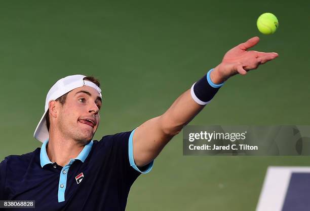 John Isner serves to Borna Coric of Croatia during the fifth day of the Winston-Salem Open at Wake Forest University on August 23, 2017 in...