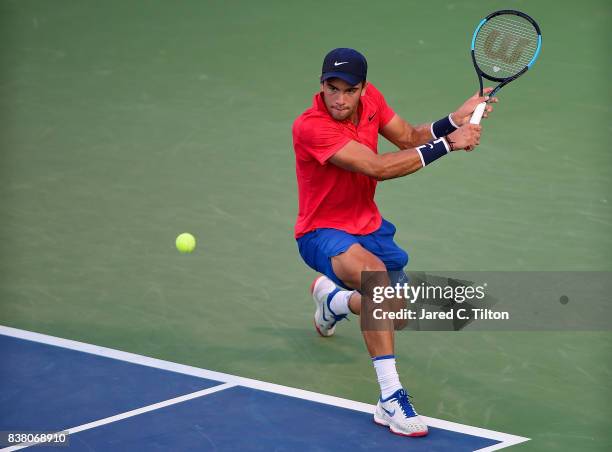 Borna Coric of Croatia returns a shot to John Isner during the fifth day of the Winston-Salem Open at Wake Forest University on August 23, 2017 in...