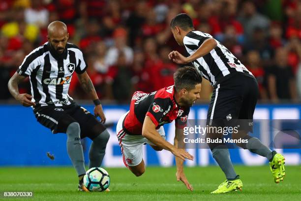 Diego of Flamengo struggles for the ball with Rodrigo Lindoso (R and Bruno Silva of Botafogo during a match between Flamengo and Botafogo part of...