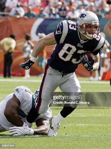 Wes Welker of the New England Patriots carries the ball after catching a pass during a NFL game against the Miami Dolphins at Dolphin Stadium on...