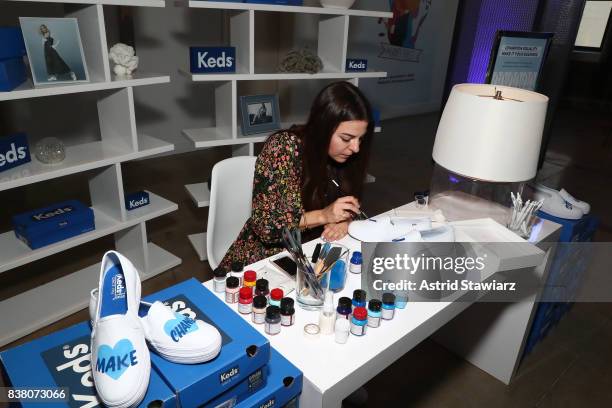 Artist paints Keds as seen during "CHAMPION EQUALITY. MAKE IT YOUR BUSINESS." panel event hosted by Keds & LOLA to celebrate Women's Equality Day at...